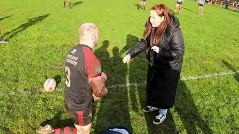 Chris proposing to Amanda on rugby field