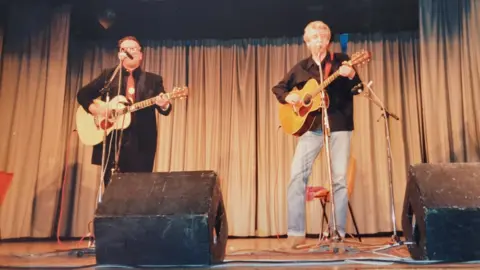 Davie Gardner Elvis Costello performing alongside Nick Lowe (r) at the 1988 Shetland Folk Festival