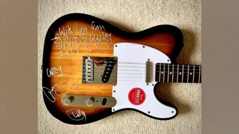 Friends of Rode and Norton schools Picture of signed guitar from Coldplay