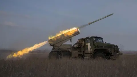 Reuters Ukrainian servicemen fire a BM-21 Grad multiple launch rocket system towards Russian positions on a frontline near the town of Marinka, amid Russia's attack on Ukraine, in Donetsk region, Ukraine, February 7, 2023