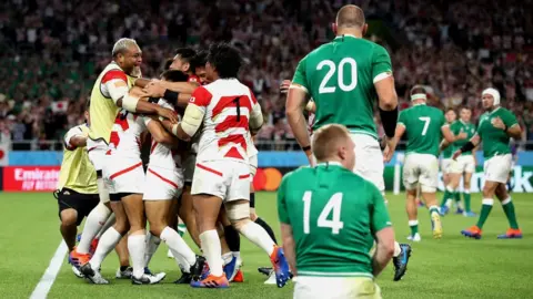 Getty Images Japanese players celebrate their shock victory against Ireland