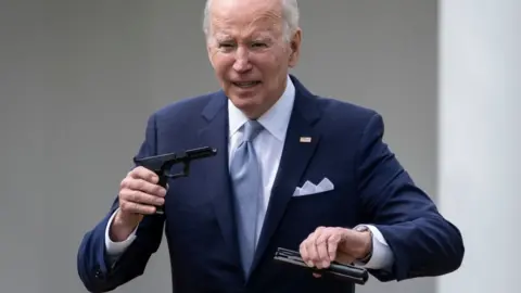 Getty Images Biden holding a gun