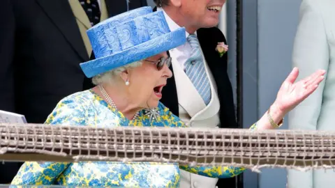 Getty Images The Queen gesturing with her hand as watches a Derby race intently