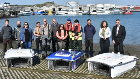 Plymouth City Council Group photo of experts from industry and academia are working together to enhance the technology behind the waste robots