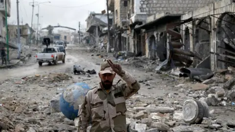 Reuters A Syrian army soldier gestures in Maarat al-Numan, Syria (30 January 2020)