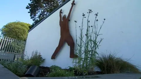 BBC The life-size memorial sculpture looks out over York Cricket Club's first-team pitch