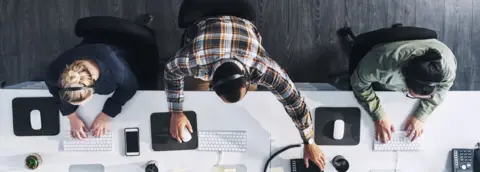 Getty Images Men and women at work