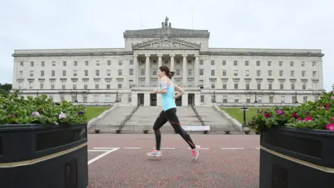 AFP A runner goes past Parliament Buildings at Stormont