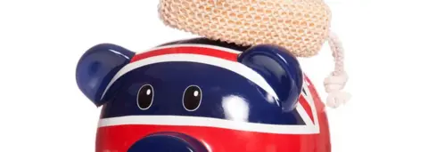 Getty Images Piggy bank with scrub