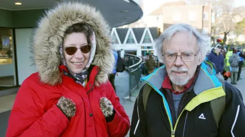 Stephen Huntley Two people standing next to each other