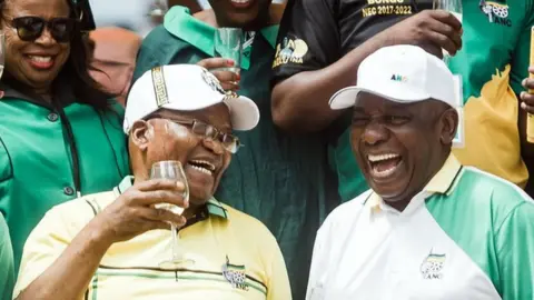 Getty Images African National Congress (ANC) President Cyril Ramaphosa (R) toasts with former President Jacob Zuma (C)