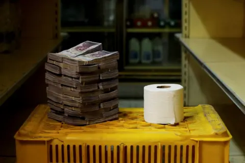 Reuters A toilet roll next to 2,600,000 bolivars