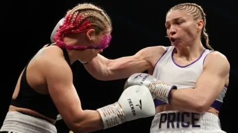 Getty Images Lauren Price punches Valgerdur Gudstensdottir during fight night London in June 2022