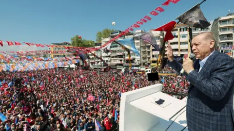 TURKISH PRESIDENCY/MURAT CETINMUHURDAR/HANDOUT Turkish President Recep Tayyip Erdogan waves to crowds at the opening of a car battery factory in Bursa