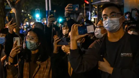 Getty Images Protesters on a street in Shanghai in November 2022