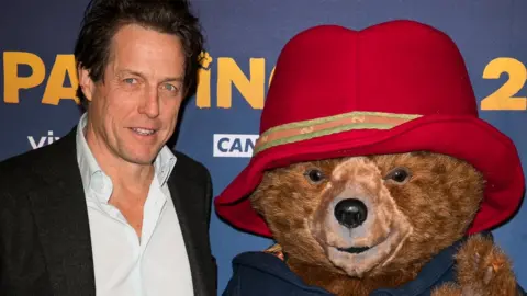 Getty Images Hugh Grant with Paddington Bear