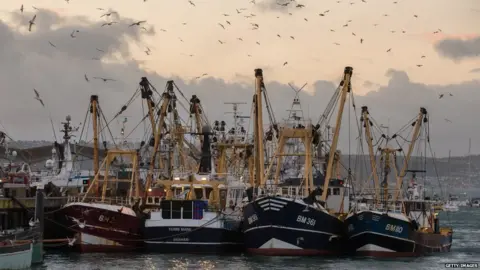 Getty Images Fishing boats moored in Brixham harbour