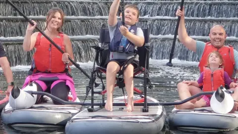 Whatsupuk Oscar paddle boarding with his family
