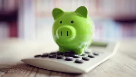 Getty Images piggy bank on calculator