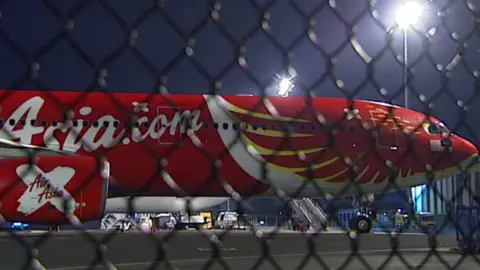 ABC The AirAsia X plane on the tarmac at Brisbane Airport