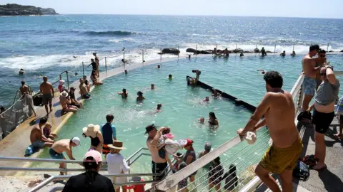 EPA Beachgoers at Bronte rock pool and beach in Sydney on 24 January