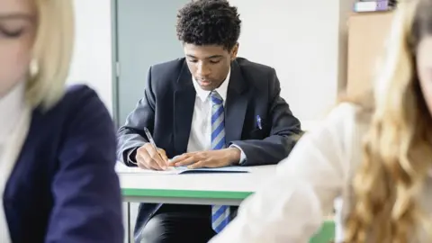 Getty Images Pupils sit school exam