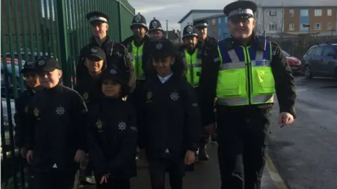 Left to right: Ahmed, Joseph, Aliyah, Alexis and Zeena on patrol with Gwent Police officers