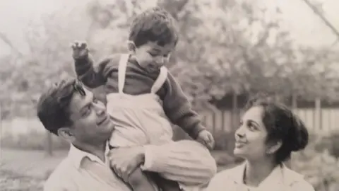 Family photo Rajan as a young boy being held by his father