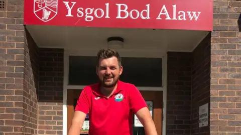 Sandra Roberts Gareth Hughes outside his school, Ysgol Bod Alaw