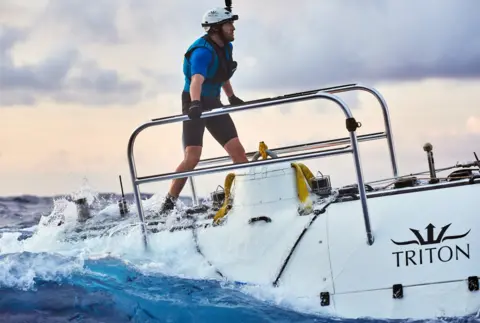 Reeve Jolliffe A member of the diving team stands on top of DSV Limiting Factor submersible