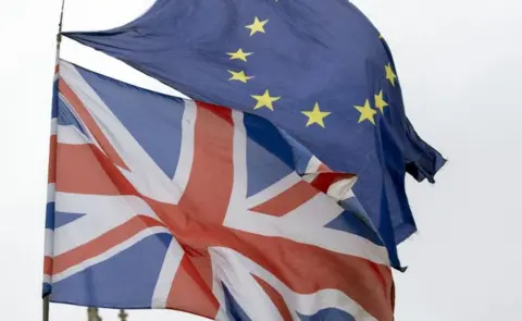 Steve Parsons/PA Wire File photo dated 12/3/2019 of Union and EU flags flying outside the Palace of Westminster, London