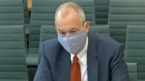 House of Commons Sir Patrick Vallance wearing a mask as he gives evidence to the science and technology committee