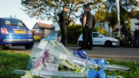 Reuters Flowers lie next to the scene where MP David Amess was stabbed