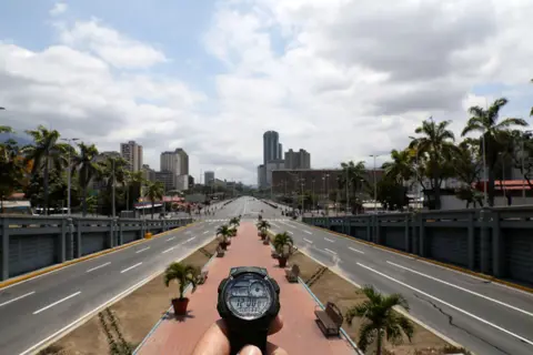 Manaure Quintero / Reuters A watch showing the time at noon in front of Bolivar Avenue in Caracas, Venezuela