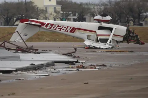 Getty Images An airplane is seen flipped on its roof at Aransas County Airport after Hurricane Harvey passed through on 26 August