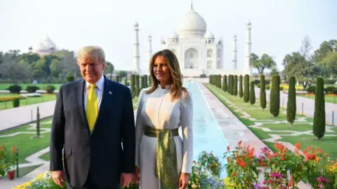 Getty Images US President Donald Trump and First Lady Melania Trump pose as they visit the Taj Mahal in Agra on February 24, 2020.