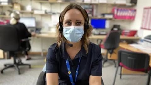 BBC Admin supervisor sits at her desk in an office