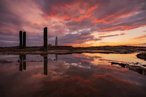 Tom Wright St Mary's Lighthouse reflected in water at sunrise