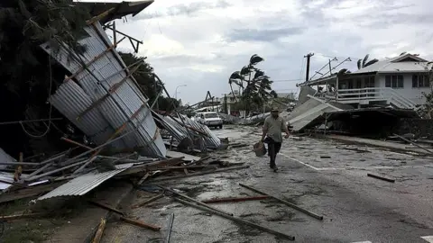 John Pulu/AFP Image shows the flooding and damage in Tonga's capital of Nuku"alofa after Cyclone Gita hit the country.