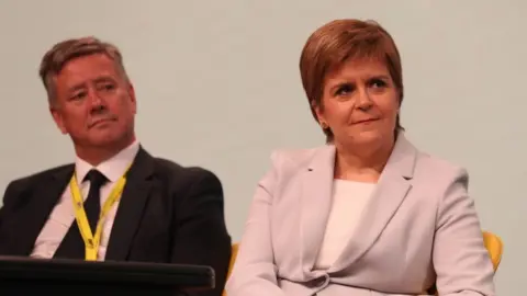 PA Keith Brown and Nicola Sturgeon