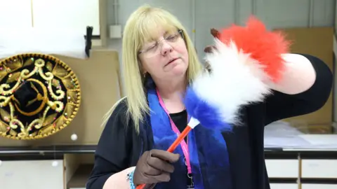 Gareth Jones Museum of Liverpool curator Karen O'Rourke with one of Sir Ken's famous tickling sticks