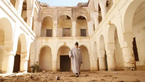 EPA A man walks at damaged in the earthquake, Tamazirt village, Marrakesh, Morocco, 22 September 2023.