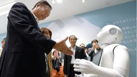 AFP/Getty Terry Gou (L), chairman and CEO of Taiwan's Foxconn Technology group, tries to shake hands with humanoid robot 'Pepper' (R), which is jointly developed by Japan's mobile carrier SoftBank and French humanoid robot maker Alderbaran and manufactured by Foxconn, at a showroom of SoftBank in Tokyo, on 6 June 2014.