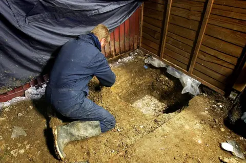 Getty Images A forensic archaeologist working in the garden of Tobin's former home in Irvin Drive, Margate