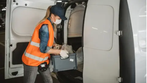 svetikd Woman loads a van - stock shot