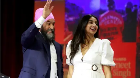 Getty Images Jagmeet Singh speaks alongside his pregnant wife