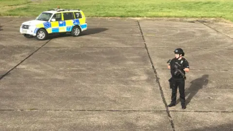 @zulu/wooloo/PA Police officer near plane