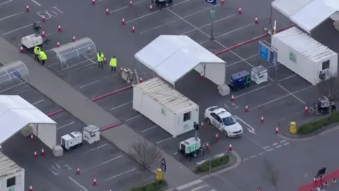 BBC A drive-through NHS testing site in Wembley, north London