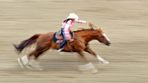 A rodeo competitor on horseback