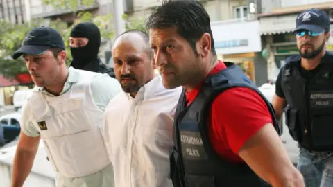 AFP Paleokostas being led by police in August 2008